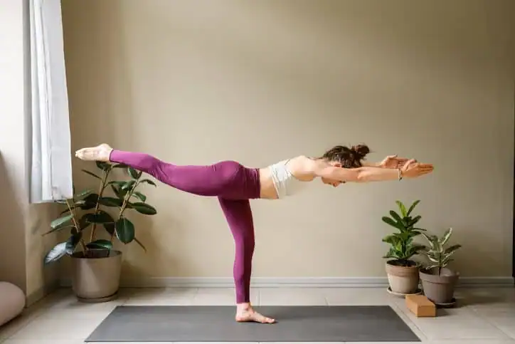 Woman doing Yoga exercise Harlow to help with toning the body. 