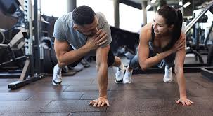 Image of man and woman doing Cardio Harlow to tone their arms. 